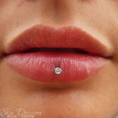 a woman's lips with a diamond in the middle