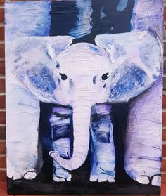 an elephant painting on a brick wall