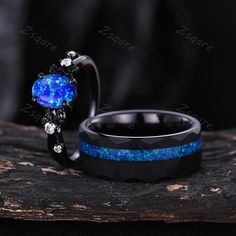 two rings with blue and black opal inlays sitting on top of each other