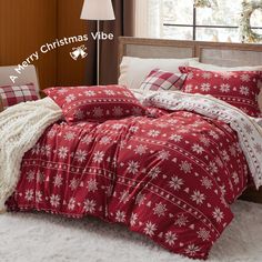 a bed with red and white snowflakes on it in front of a window