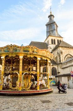 a merry go round in front of an old church