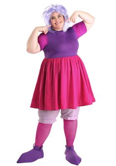 a woman dressed in purple and pink poses for the camera with her hands on her hips