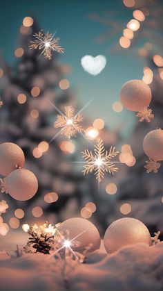 snowflakes and balls are floating in the air near a christmas tree with lights