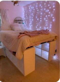 a bedroom with lights on the wall and a bed in it's centerpiece