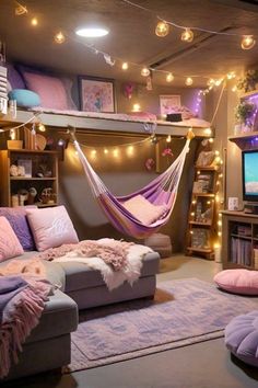 a living room filled with lots of furniture and lights hanging from the ceiling above it