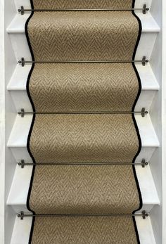 a stair case with beige carpet and white trim