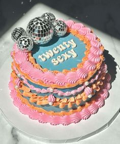 there is a cake that has been decorated with disco balls and the words happy birthday on it