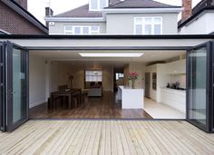 an open living room and dining area with sliding glass doors that lead into the kitchen