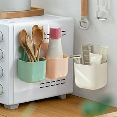 a toaster oven with utensils and spoons in it