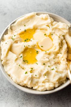 a bowl filled with mashed potatoes and butter