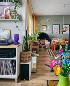 a living room filled with furniture and lots of plants