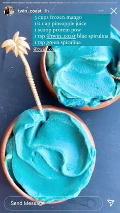 two small bowls filled with blue frosting next to a palm tree on top of a table