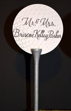 a golf ball on a tee with the words mr and mrs bruce kelly parker