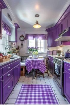 a kitchen with purple cabinets and checkered table cloth