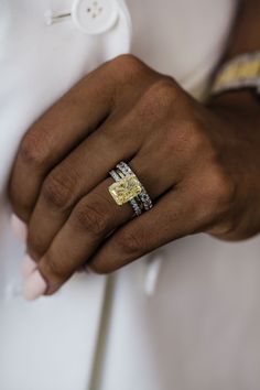 a close up of a person wearing two rings