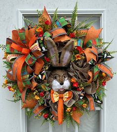 a wreath with an animal's head on it is hanging on the front door