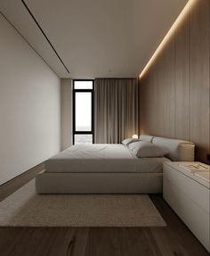 a large white bed sitting next to a window in a room with wooden flooring