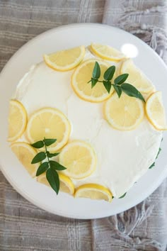 a cake with lemons and leaves on it