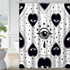 a shower curtain with an all seeing eye design on it, in black and white