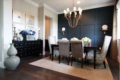 a dining room table with chairs and a chandelier