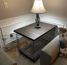 a lamp is sitting on top of a table with a cage in front of it