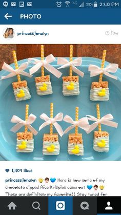 small desserts are arranged on a blue plate with white bows and yellow candies