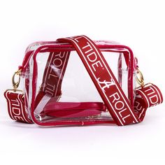 Showcase your Alabama Crimson Tide spirit with this Bridget Clear Purse with Logo Strap. This stylish and functional purse is crafted from clear vinyl to be stadium compliant, with straps accented with brass hardware for a touch of elegance. It features two adjustable, interchangeable straps, allowing you to switch up your look effortlessly, whether you're heading to a Alabama Crimson Tide game or out on the town. Bama Gameday Outfit, Clear Purses, Alabama Roll Tide, The University Of Alabama, White Purses, Clear Bag, University Of Alabama, Roll Tide