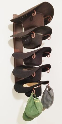 a wall mounted shoe rack with several pairs of shoes hanging from it's sides