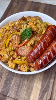 two sausages and macaroni in a white bowl