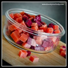 chopped beets in a glass bowl on a cutting board next to some diced carrots