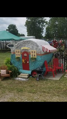 a house made out of a boat in the yard