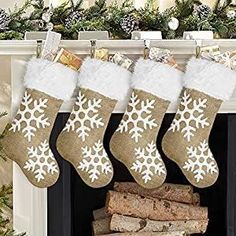 stockings hanging from a fireplace with snowflakes on them