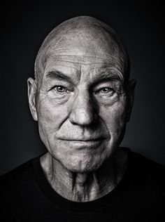 black and white photograph of an older man with wrinkles on his face, looking at the camera