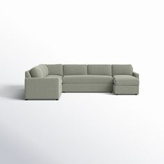 a large sectional couch sitting on top of a white floor