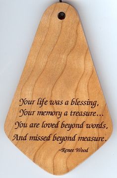 a wooden plaque with a quote on it that says your life was a blessing, your memory a treasure you are loved beyond words and missed beyond measure