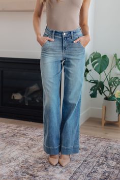 Cozy, light wash denim and wide leg cut, these Mid Rise Jeans are a year-round closet essential! Featuring a mid-rise waist with slanted pockets, zipper fly, and lived-in fading for a laid-back look. Perfect for those days when you just want to feel comfy and look fab! The acid wash process used to manufacture these amazing jeans may cause a variation in coloring from pair to pair! Judy Blue Mid-Rise Zip Fly 4-Way Stretch Trouser Hem Slanted Pockets Wide Leg Fit Fit: Sizes 1-15 are junior sizing Judy Blues, Flamboyant Natural, Perfect Closet, Jean Large, Judy Blue Jeans, Carpenter Jeans, Plus Size Swimwear, Light Wash Denim, Sweater Blouse