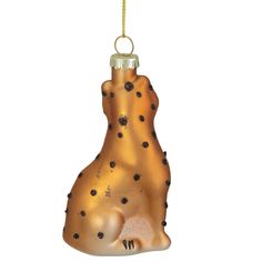 a golden dog ornament hanging from a gold chain