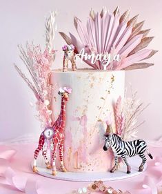 there is a cake decorated with giraffes and zebras