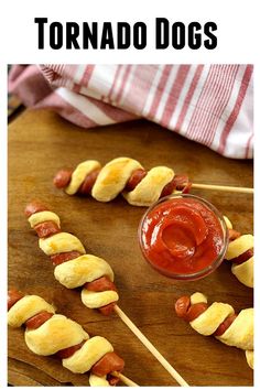 hot dogs on skewers with ketchup are ready to be eaten and served