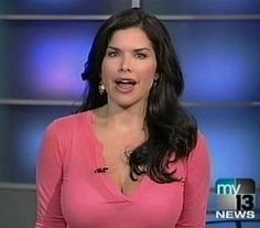 a woman in a pink shirt is talking to someone on the tv news set with her mouth open