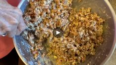 a person mixing food in a bowl on top of a table