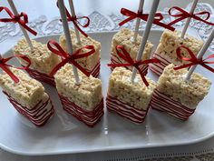 marshmallow treats with red ribbons on a white plate