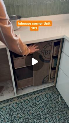 a person reaching into an open cabinet in a kitchen