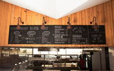 a restaurant with menus hanging from the ceiling and wood paneling on the walls