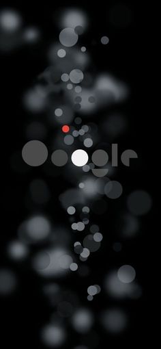 blurry circles on black background with red dot in center and white dots at the bottom