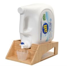 a gallon of milk sitting on top of a wooden stand