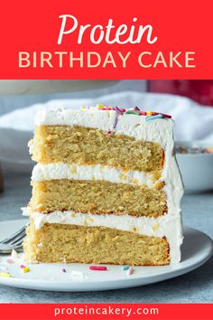 a piece of cake with white frosting and sprinkles on top is sitting on a plate