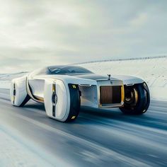 the futuristic car is driving down the snowy road