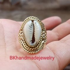 Cowrie Ring, Cowrie Shell Ring, Beach Shell Ring, Beach Cowrie Ring,Indian style Cowrie shell silver tone ring Handmade item Gemstone :-  Cowrie shell Merarial :- Brass, 925 Sterling Silver, Gold plated ,Rose Gold plated\ Style:- Boho & hippie This ring will definitely become one of your favorite piece-the ring makes a statement of its own. The ring was manufactured in India and part of a limited edition collection. For More Products Visit Mt Gold Ocean-inspired Rings For Beach, Handmade Rings For Beach, Handmade Open Ring Jewelry For Beach, Ocean-inspired Silver Rings For The Beach, Silver Shell With Ocean-inspired Style For Vacation, Silver Ocean-inspired Shell For Vacation, Gold Shell Rings For Beach, Handmade Gold Rings For Beach, Handmade Gold Rings For The Beach