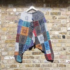 a multicolored jacket hanging on a brick wall